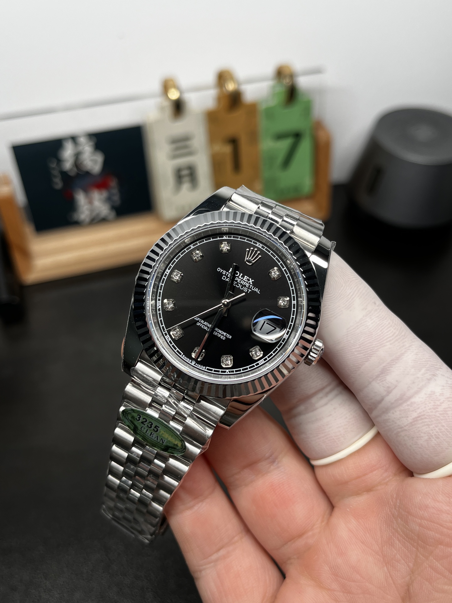 Rolex replica Datejust angled view showing black dial and Jubilee bracelet
