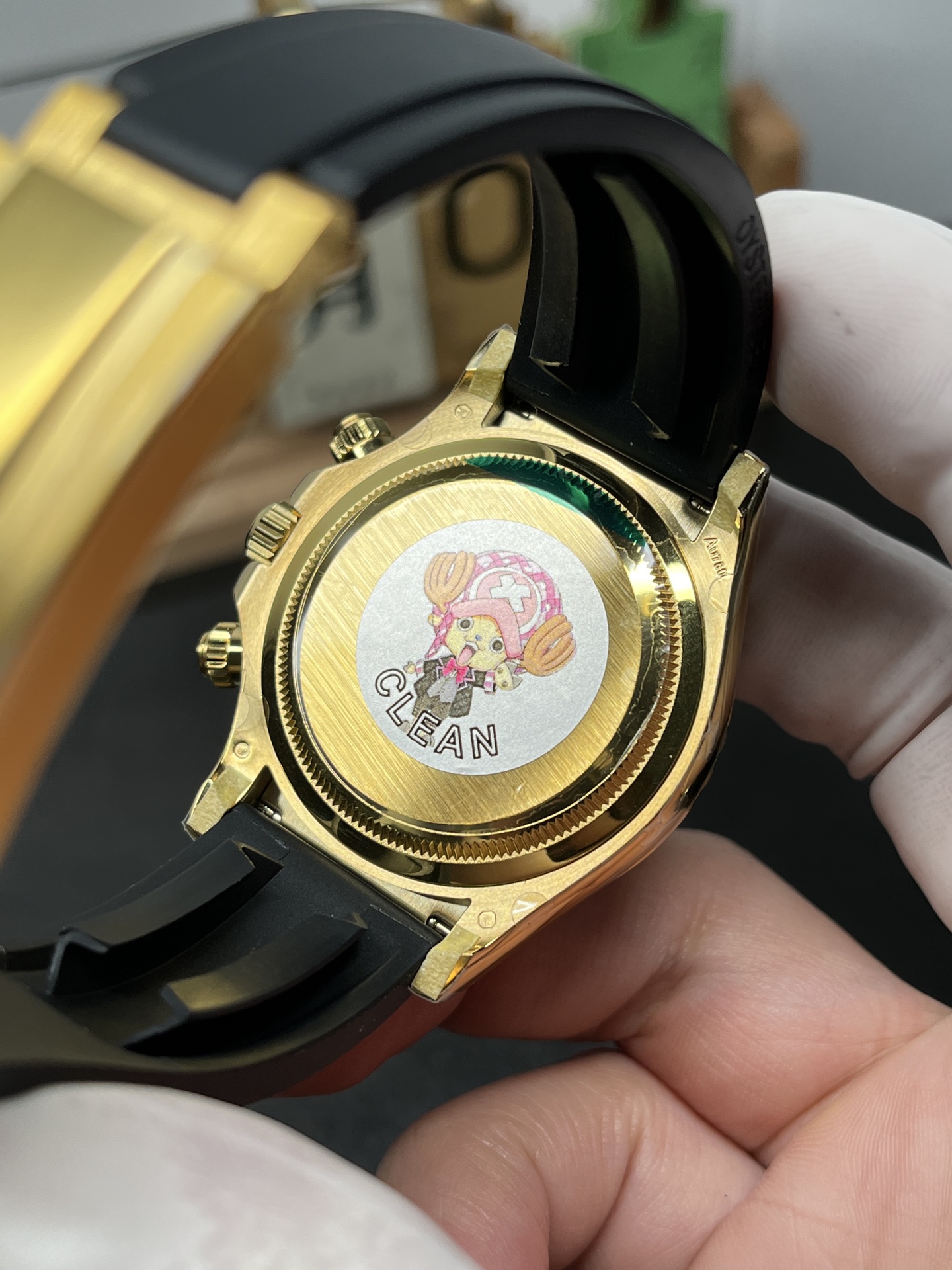 Caseback view of gold Rolex Daytona style watch showing assembly finish and quality control markings