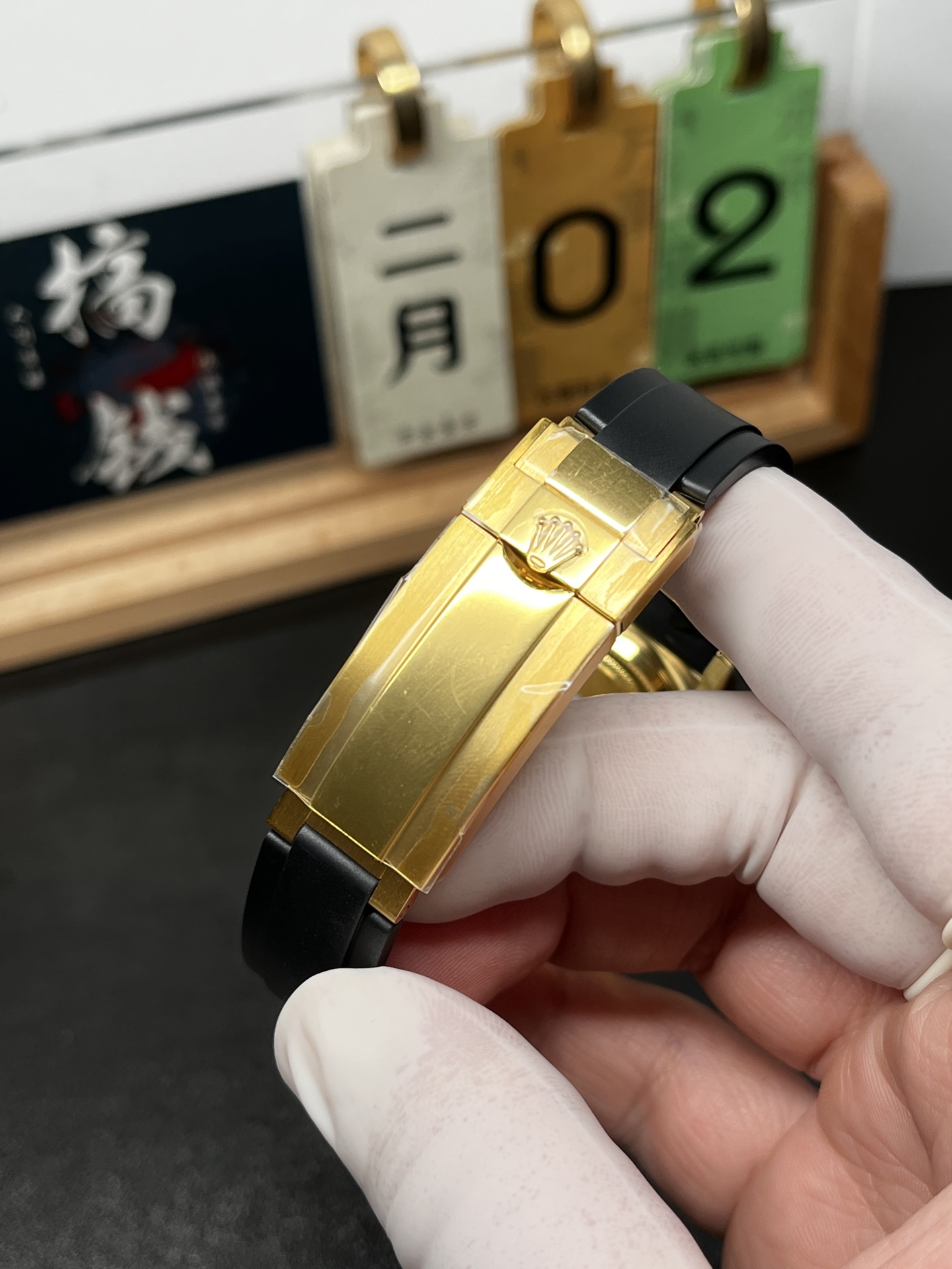 Gold Rolex Daytona style clasp detail with Oysterflex rubber strap and solid folding mechanism